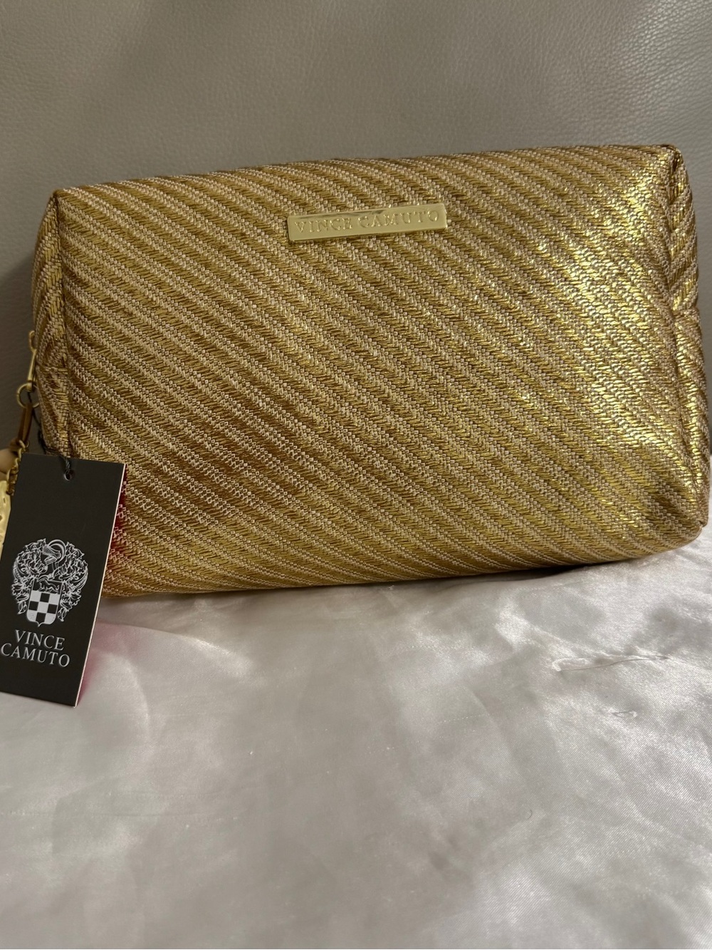 Vince Camuto gold woven canvas metallic cosmetic Bag with starfish Tassel charm.